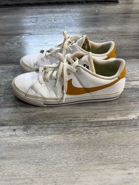 Nike White Low-Top Sneakers with Yellow Swoosh